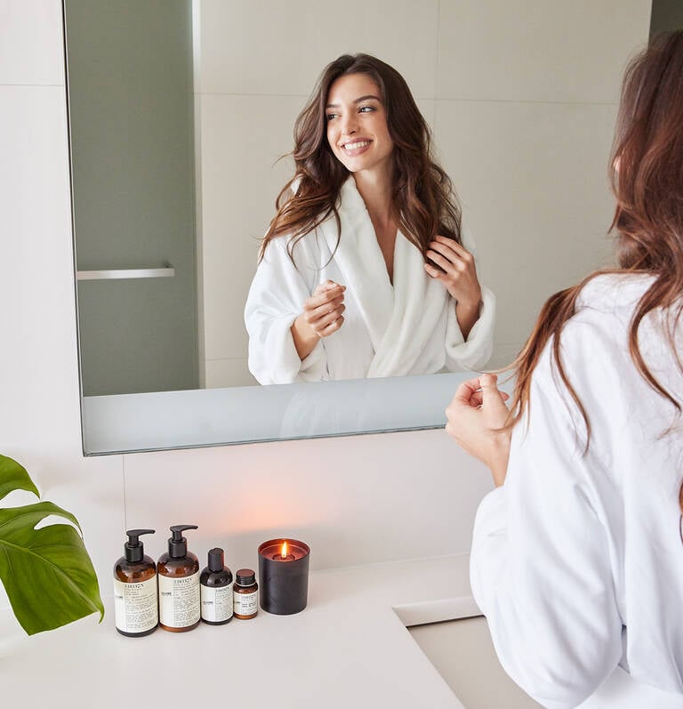 Woman in bathroom with EDITION Le Labo bath products Woman in bathroom with EDITION Le Labo bath products