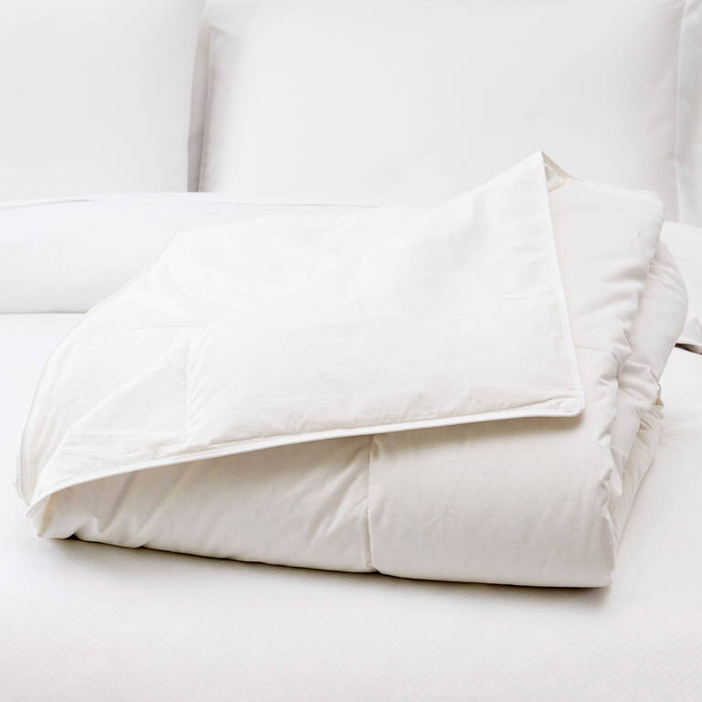 St. Regis lightweight duvet insert folded on bed