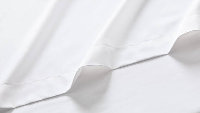 Detail closeup of Marriott Bonvoy Boutiques white bedsheets