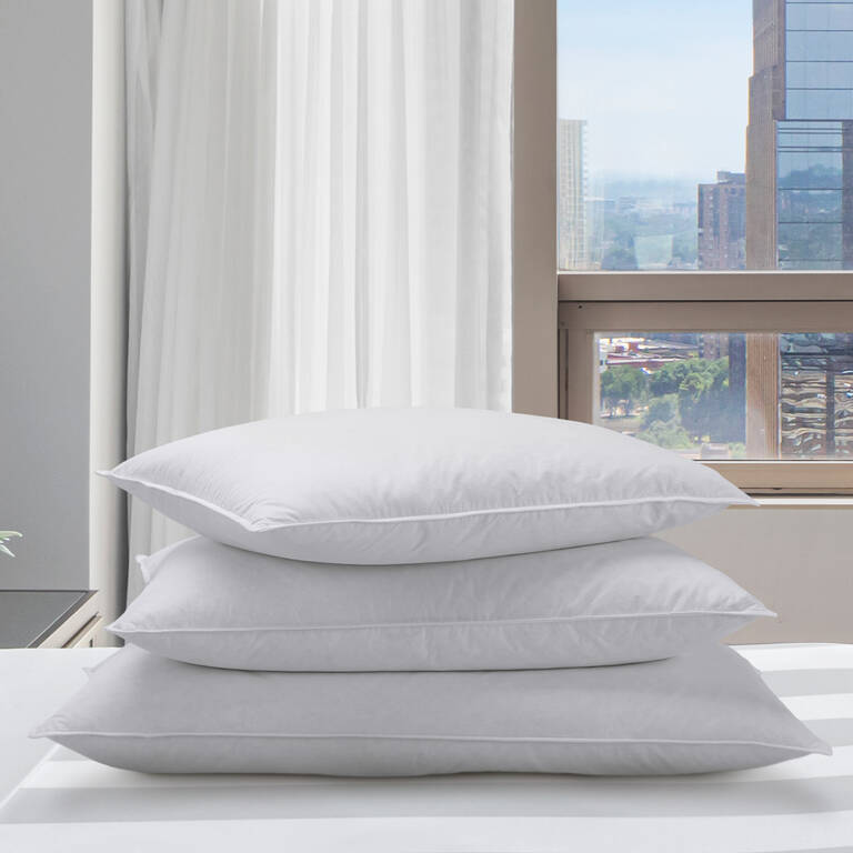 Stack of Marriott Hotels pillows in bedroom
