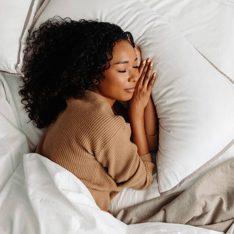 Woman sleeping in Westin Heavenly Bed with complete Westin bedding set