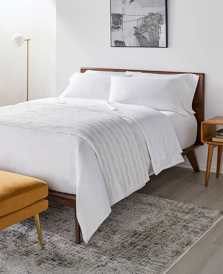 Le Meridien bed styled with multiple layers of bedding