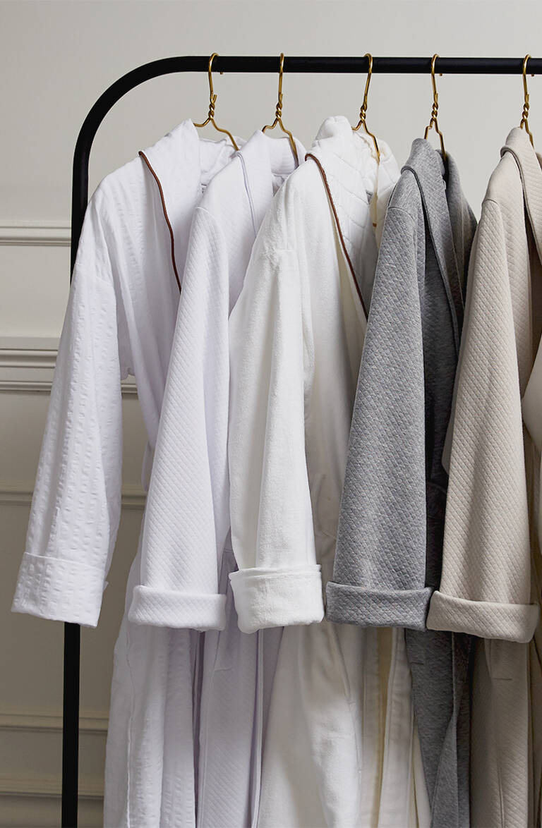 St. Regis hotel robes hanging on rack