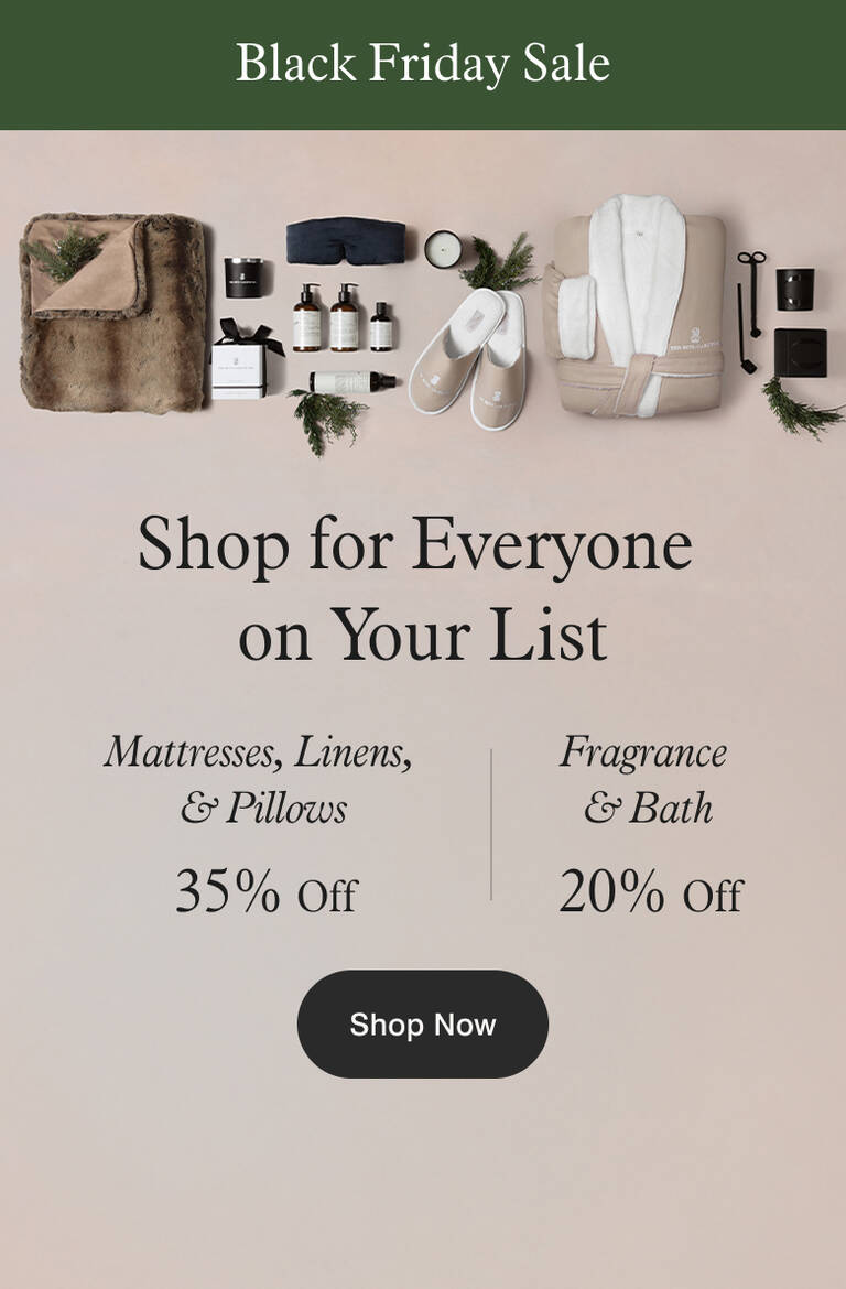 Assortment of Marriott Bonvoy Boutiques products like throw blanket, robe, slippers, bath amenities, candles, and sleep mask