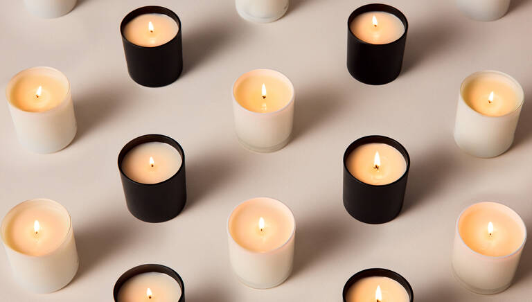 Pattern of alternating white and black Marriott Bonvoy Boutiques lit candles