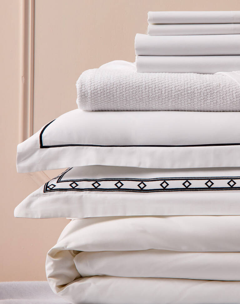 Tall stack of Marriott Bonvoy Boutiques folded bedding products