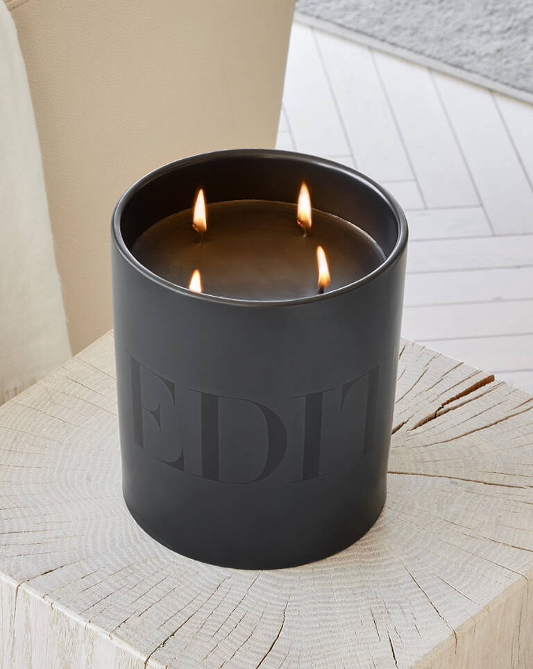 Signature black EDITION candle with lit flame