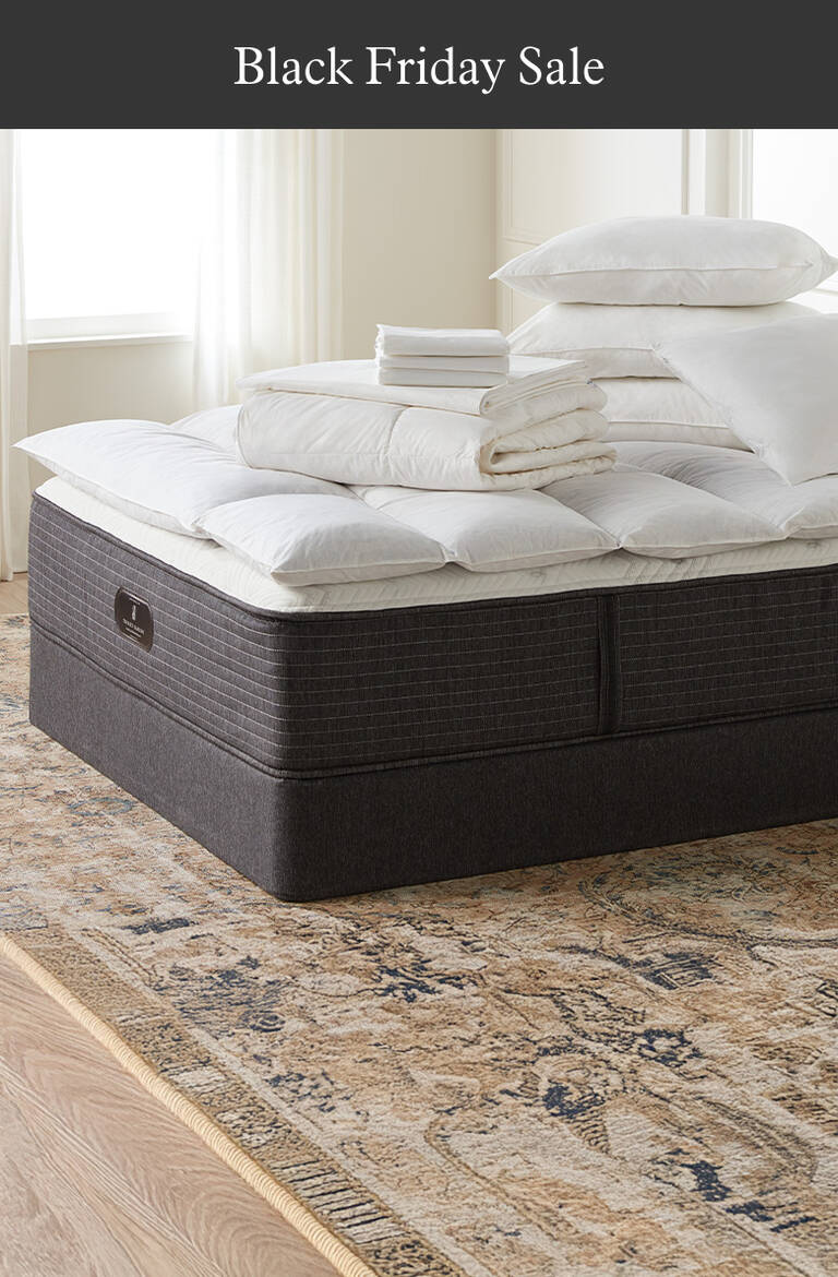 Assortment of The Ritz-Carlton bedding products on mattress