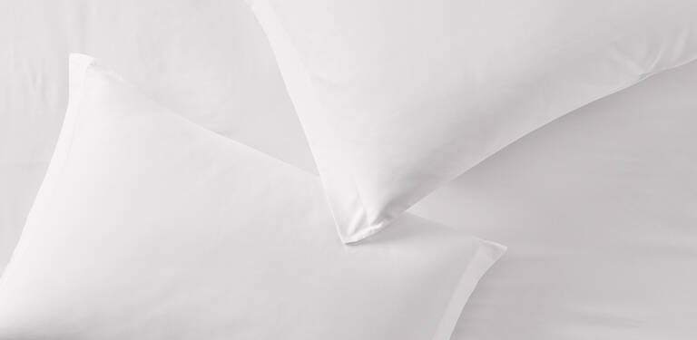 Marriott Bonvoy Boutiques pillows on bed Marriott Bonvoy Boutiques pillows on bed