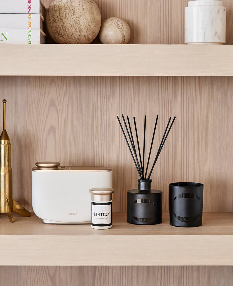 The Ritz-Carlton white candle with lemon scent notes