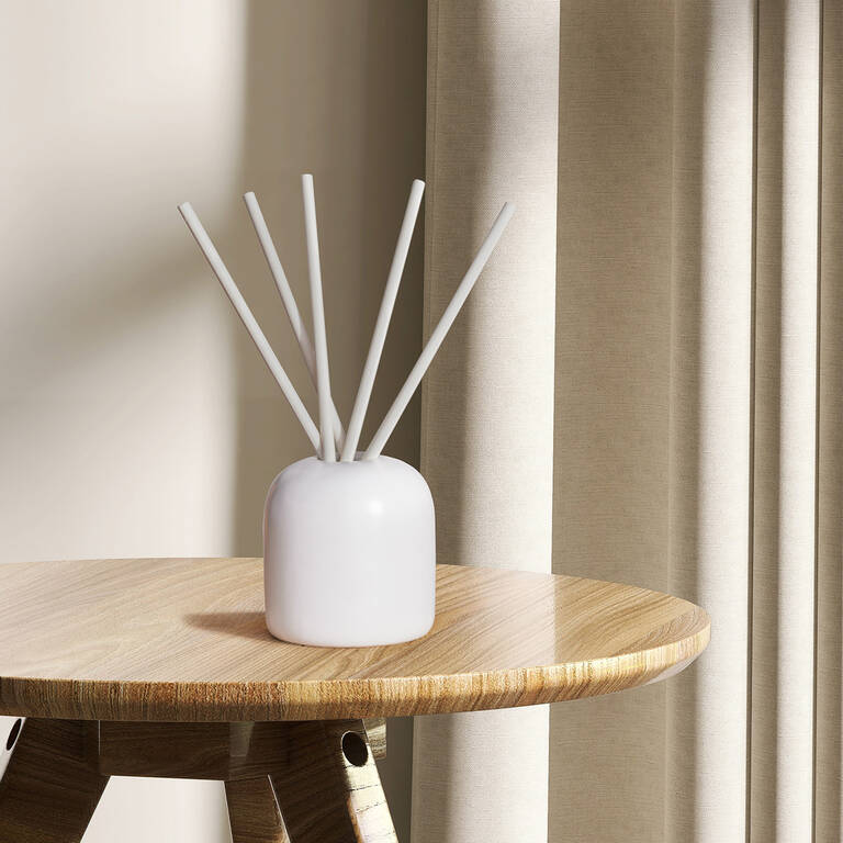JW Marriott white reed diffuser on wooden table JW Marriott white reed diffuser on wooden table