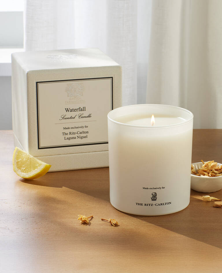 The Ritz-Carlton white candle with lemon scent notes