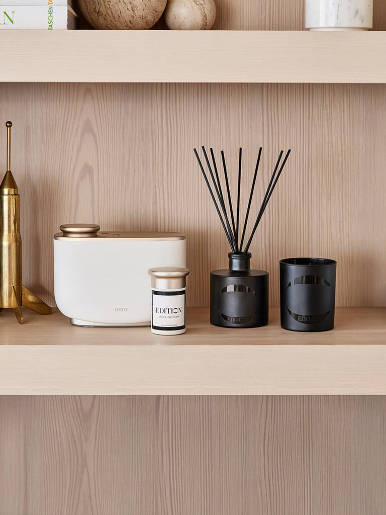EDITION home diffuser, reed diffuser, and signature candle on shelf EDITION home diffuser, reed diffuser, and signature candle on shelf